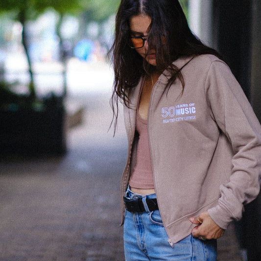 Sisi wearing a 50 Years of Music Austin City Limits zip up hoodie