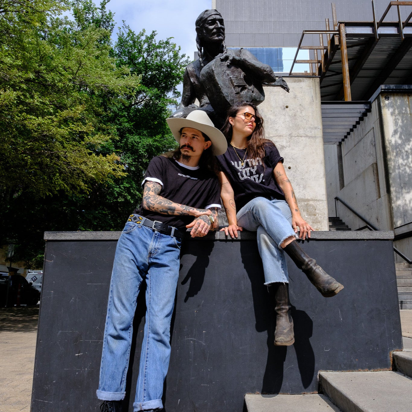 Paul Val and Sisi wearing acl logo tees at Willie Nelson statute