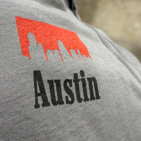 Gray fabric with red and black 'Austin' logo illustrating the front graphic