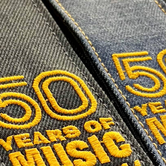 HEROES BLACK DENIM GUITAR STRAP WITH ACL + 50 YEARS OF MUSIC LOGO