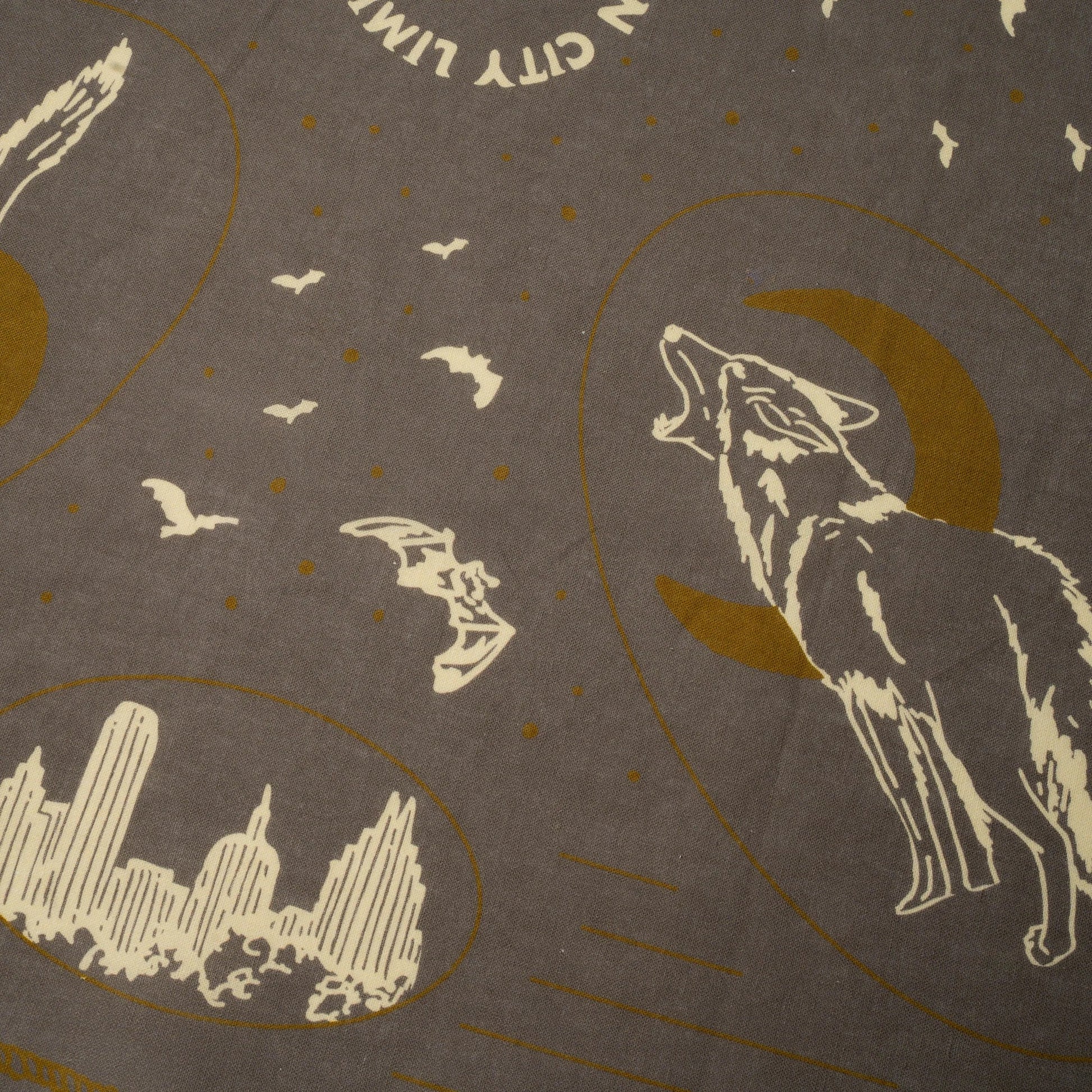 Decorative design with a wolf, moon, city skyline, and birds on a brown background.