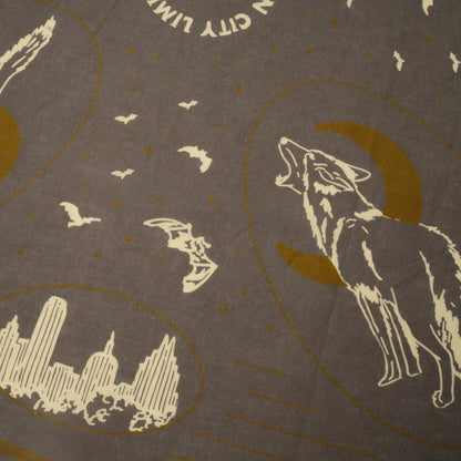 Decorative design with a wolf, moon, city skyline, and birds on a brown background.