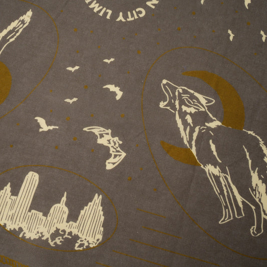 Decorative design with a wolf, moon, city skyline, and birds on a brown background.