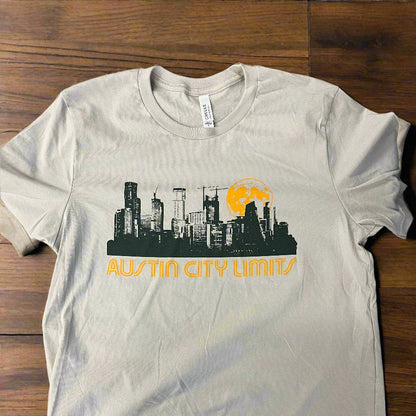 White t-shirt with graphic design on a wooden surface