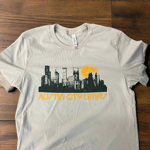 White t-shirt with graphic design on a wooden surface