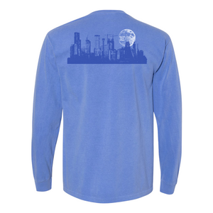 Blue long-sleeve shirt with a cityscape design on the back against a white background