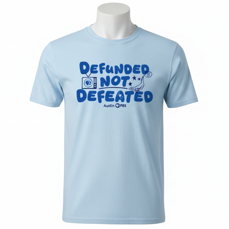 Light blue t-shirt with 'Defunded Not Defeated' text on a blue background