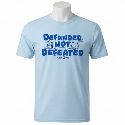 Light blue t-shirt with 'Defunded Not Defeated' text on a blue background