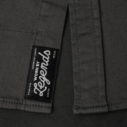 Close-up of a label on a dark fabric with 'Worn by Legends' branding.