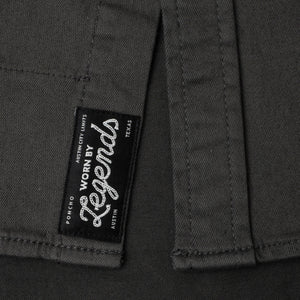 Close-up of a label on a dark fabric with 'Worn by Legends' branding.