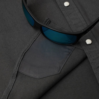 Black sunglasses with blue lenses on a dark gray fabric background