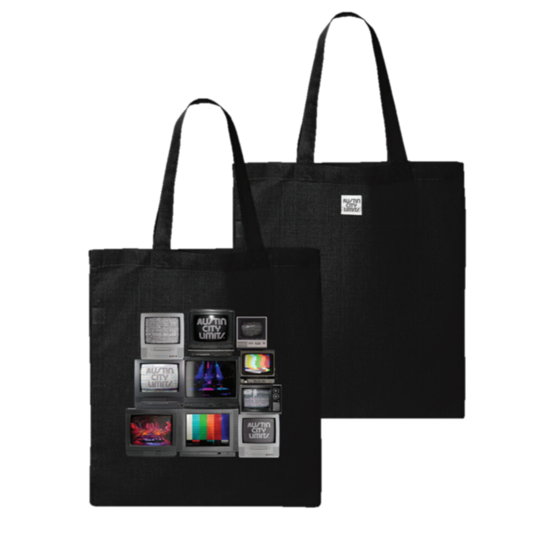A black cotton tote bag featuring a central graphic of stacked vintage televisions with a Austin City Limits woven label on the bottom right.
